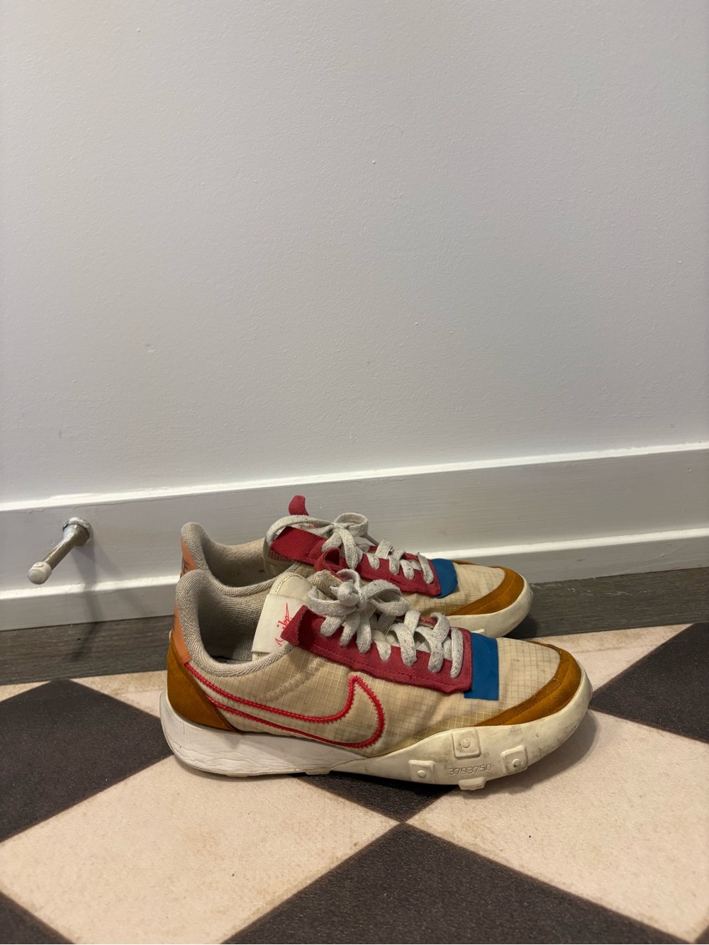 Nike Cream Sneakers with Red, Blue, and Tan Accents